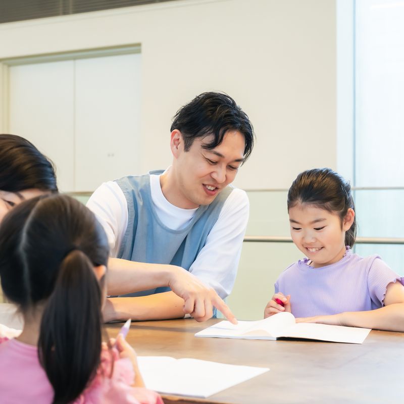 ボランティアと本を読みながら交流するこども(イメージ)